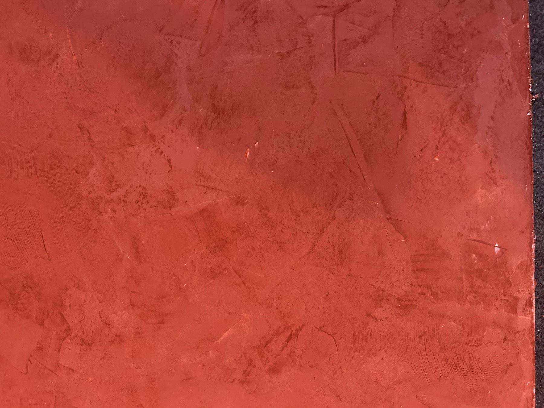 Red Veneziano plaster sample with hand-troweled texture