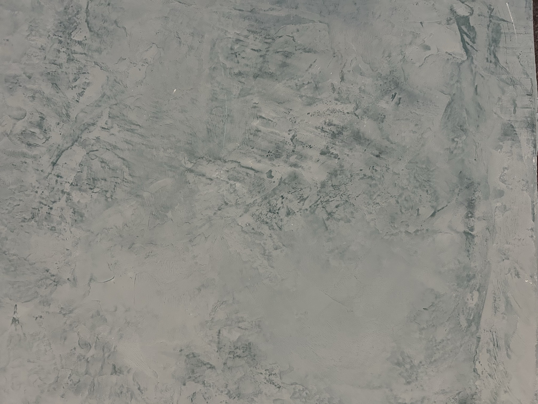 Gray-green Veneziano plaster finish sample showing subtle mineral variation
