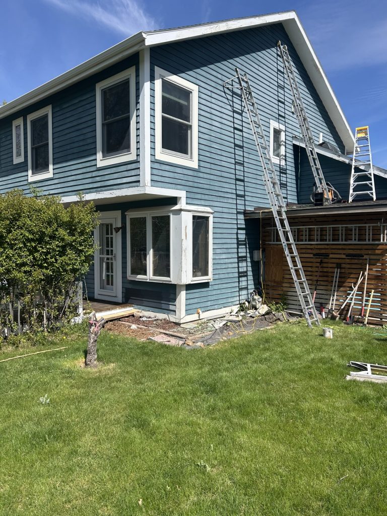 Before photo 2 of the blue home exterior repaint project